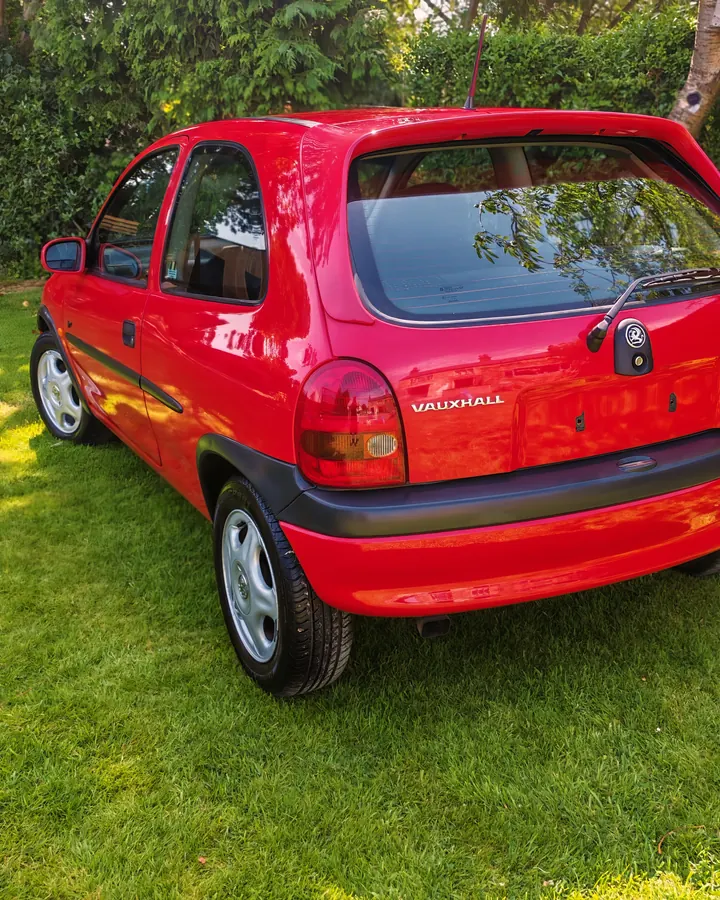 Red Vauxhall Corsa on a lawn