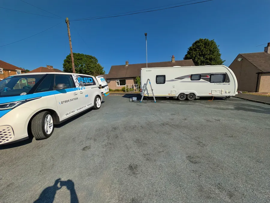 SSD van parked beside a caravan being cleaned